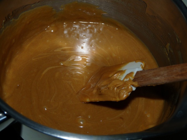 Bring corn syrup, sugar and brown sugar to a boil. Stir in peanut butter and vanilla.