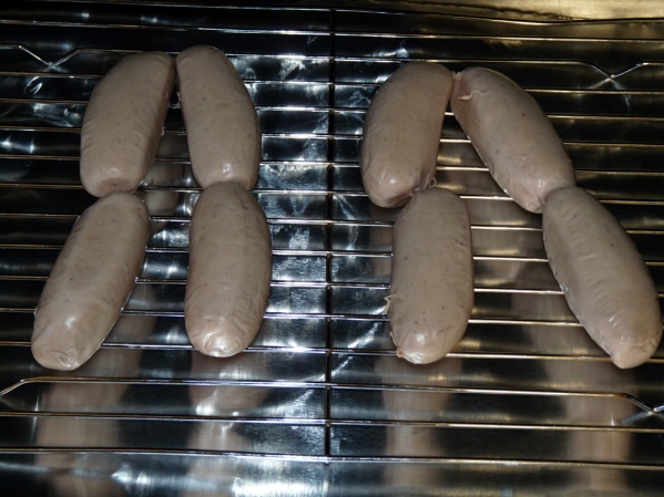 Place bangers on a rack over a foil covered sheet pan. I didn't cut them up, you could if you prefer