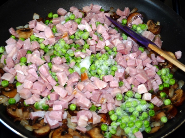 Add ham and peas and cook several minutes until heated through