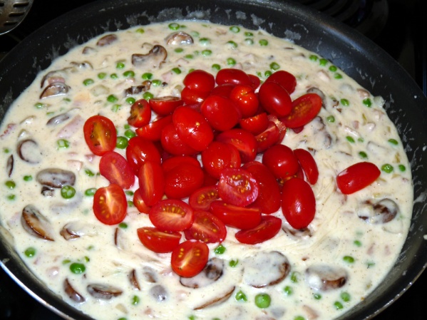 Slowly add milk and cream until sauce is smooth. Continue to cook until sauce thickens. Stir in tomatoes