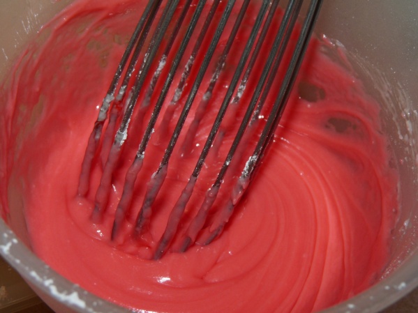 Whisk powdered sugar, heavy cream, lemon extrat and melted butter until smooth. Add food coloring to desired shade. Pour over cake.