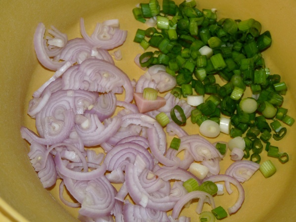 Add thinly sliced shallots and green onions to a large bowl.