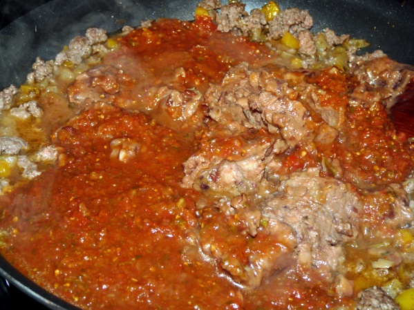 Add salsa or tomato sauce and seasonings and stir until no lumps of refried beans remain.